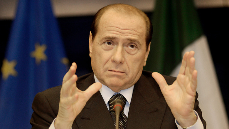 Silvio Berlusconi with hands up