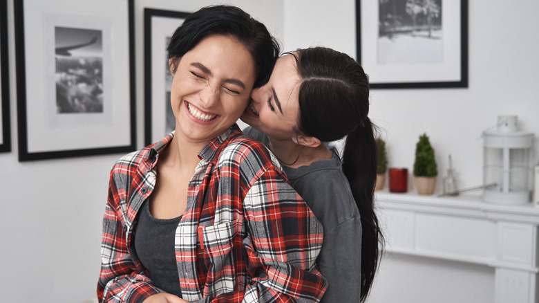 Two women hugging and kissing