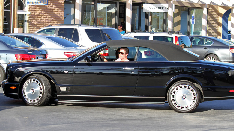 Simon Cowell driving a black car 