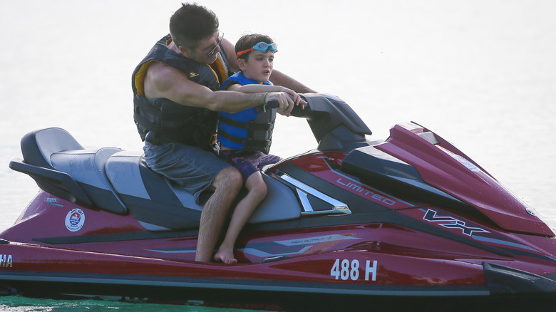 Simon Cowell and Eric Cowell on a jet ski