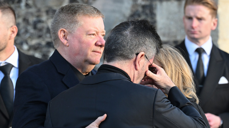 Simon Cowell hugging Geoff and Karen Payne