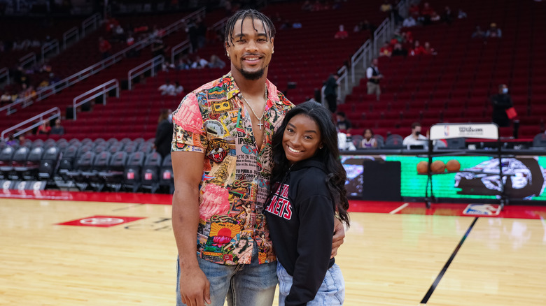 Jonathan Owens stands next to wife Simone Biles