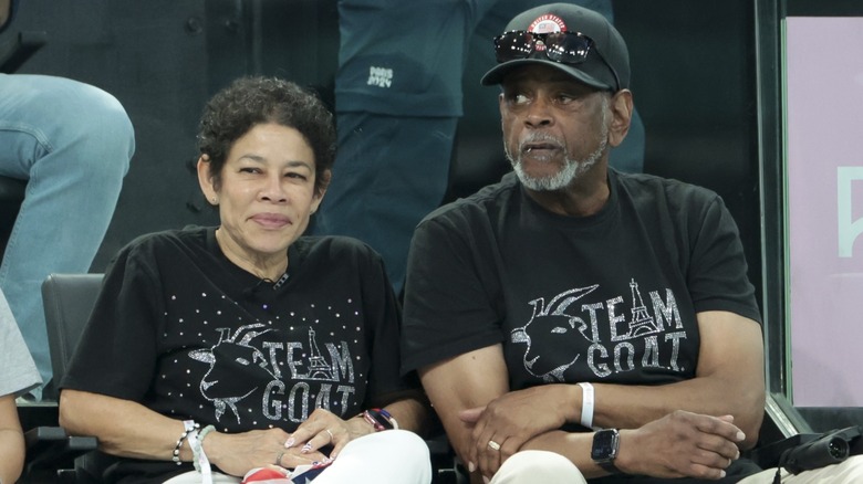 Nellie Biles Ronald Biles sitting in 'Team G.O.A.T.' shirts