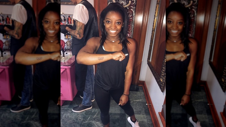 Simone Biles showing Olympics tattoo on wrist