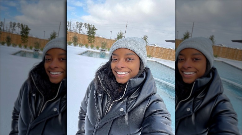 Simone Biles takes a selfie by her pool