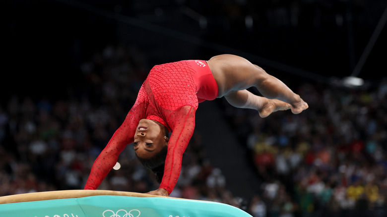 Simone Biles red leotard on vault