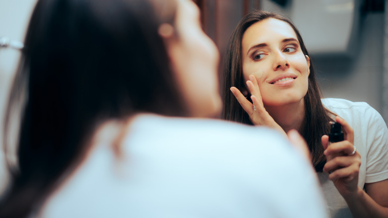 woman applying foundation