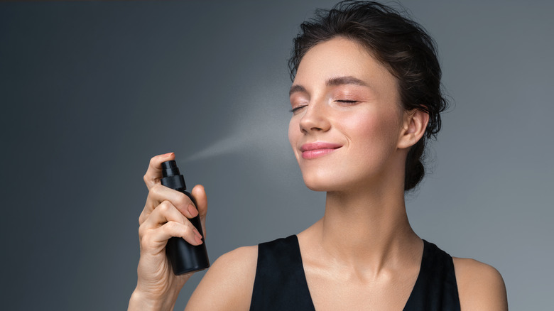 woman applying setting spray