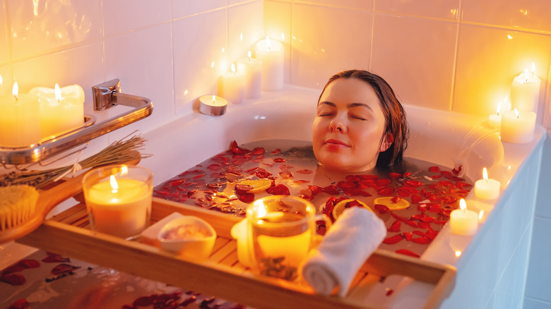 woman relaxing in rose petal bath