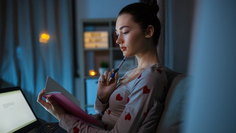 woman journaling in bed