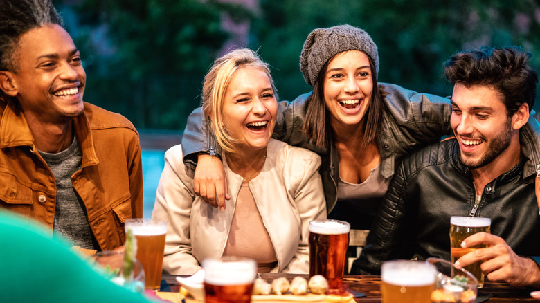 friendship group laughing over beers