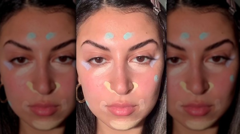 A woman wearing color correcting makeup