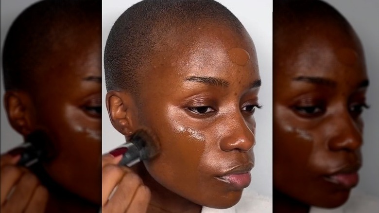 A woman applying foundation