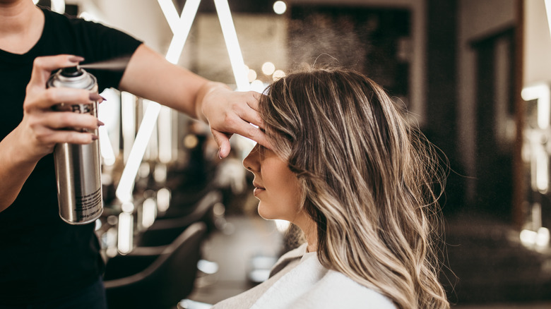 Stylist spraying product