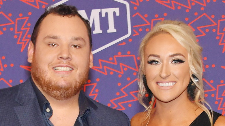 Luke Combs and Nicole Hocking pose on the red carpet together