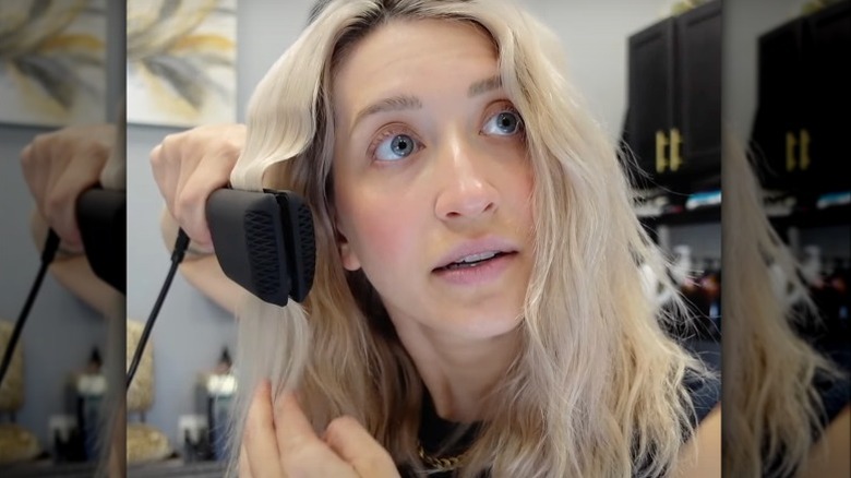 Woman using double-waver hair tool 