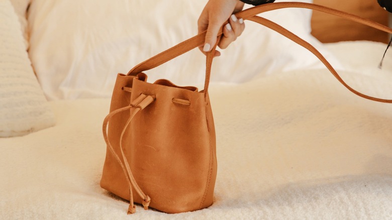 Woman holding a Parker Clay bag