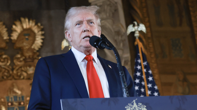 Donald Trump speaking at a podium