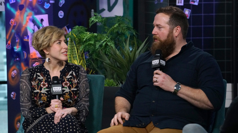 Erin and Ben Napier holding microphones