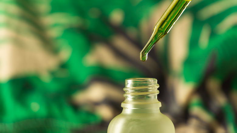 Facial oil with plant background