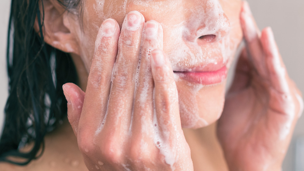 A woman washing her face