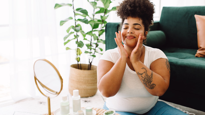 Smiling woman doing her skincare