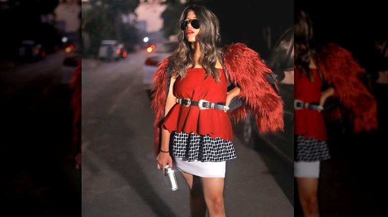 Woman wearing black, white, and red outfit