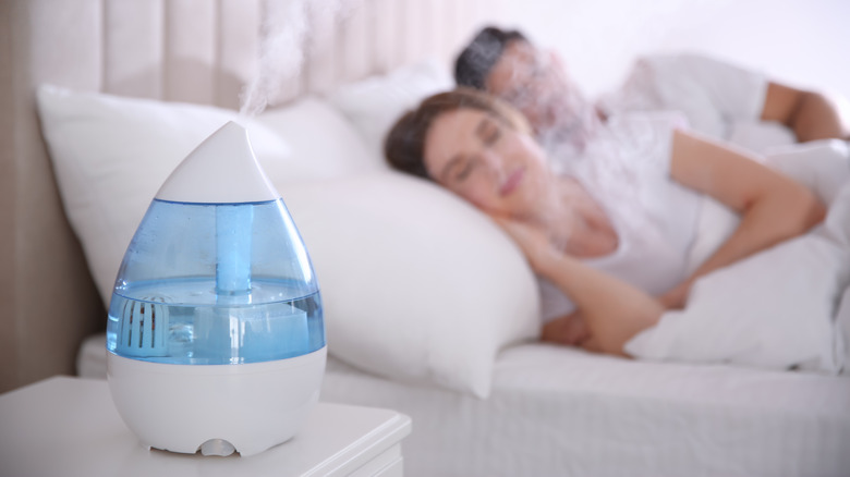 Happy couple sleeping with humidifier