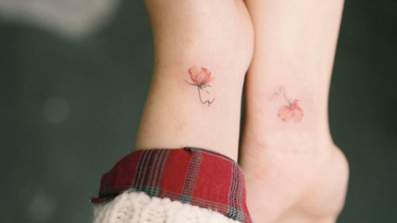 two matching flower wrist tattoos by Sol Ink Tattoo