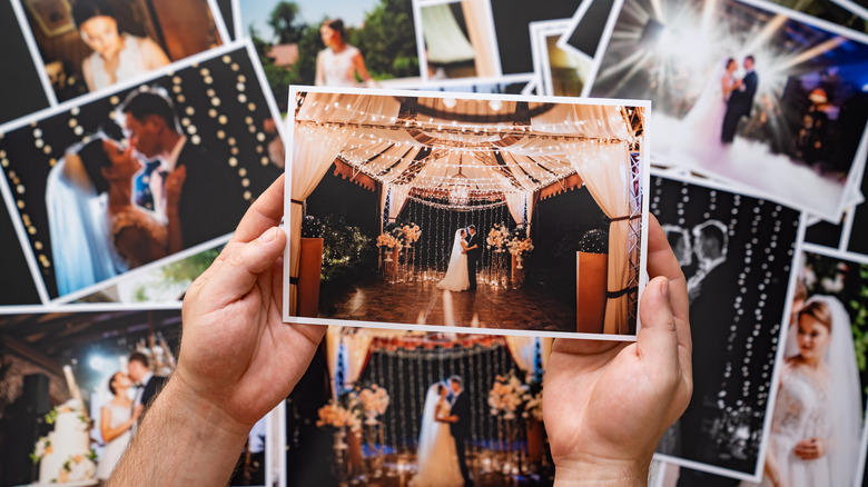 man going through wedding photos