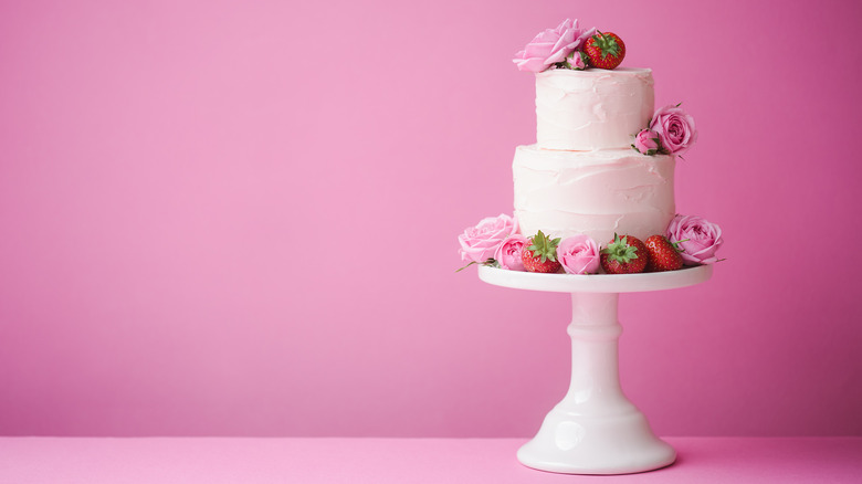 side of a wedding cake with real flowers