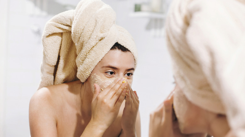 Woman using face scrub