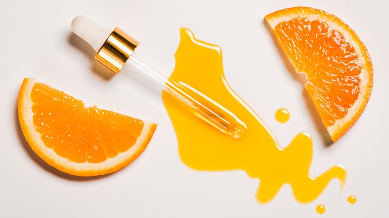 orange slice with vitamin c dropper