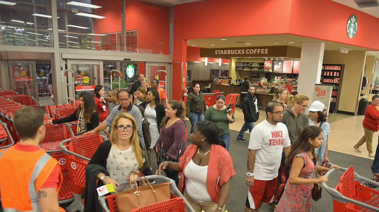 People shopping at a Target with a Starbucks in it