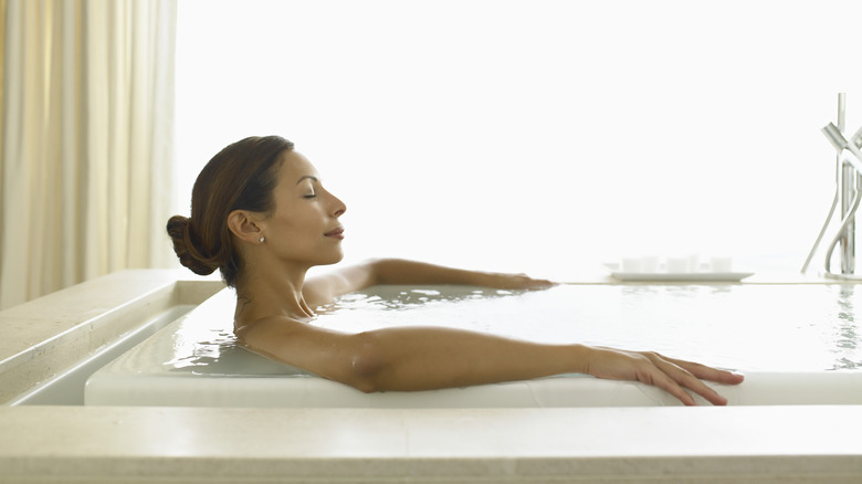 A woman soaking in the bath. 