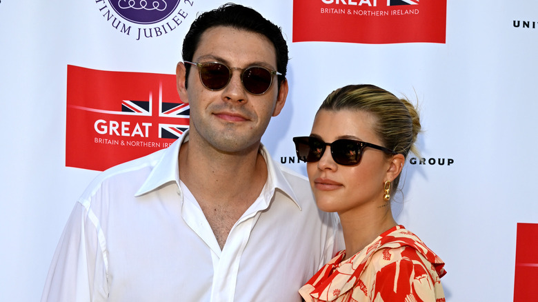 Elliot Grainge and Sofia Richie wear sunglasses on red carpet