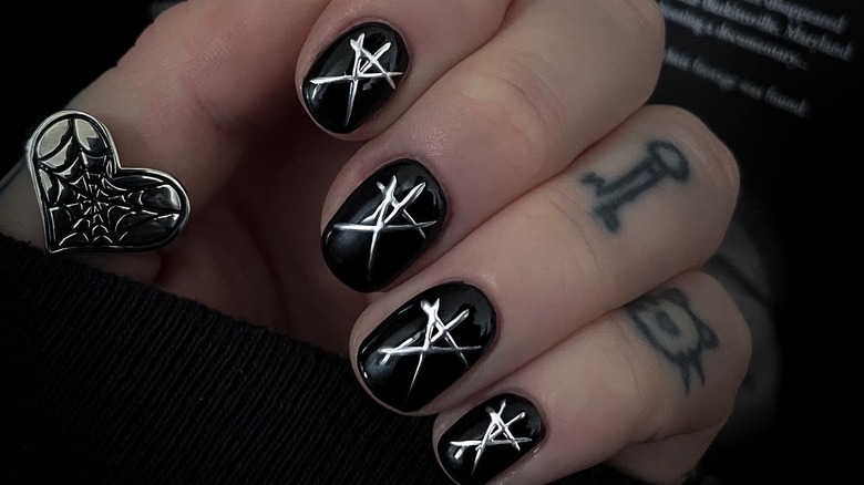 Black nails with silver symbols