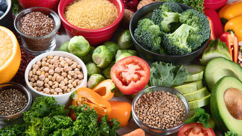 table full of nutrient-rich ingredients: nuts, avocado, broccoli, etc...