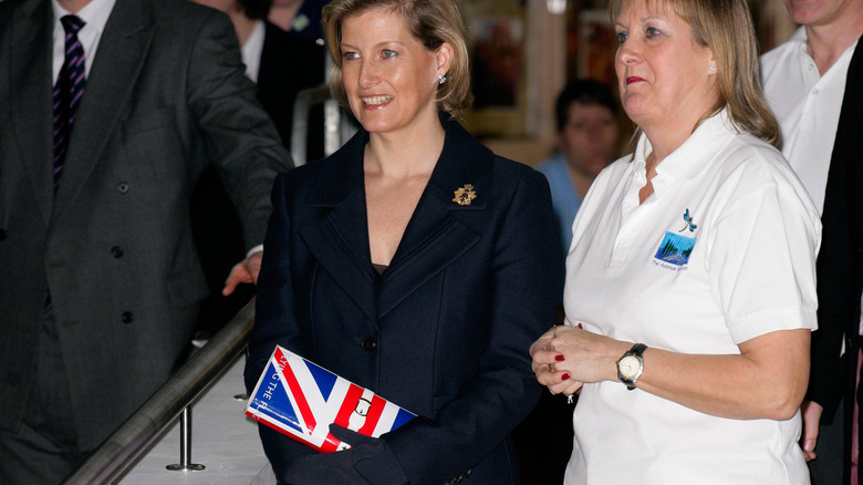 Countess of Wessex holding a British flag handbag