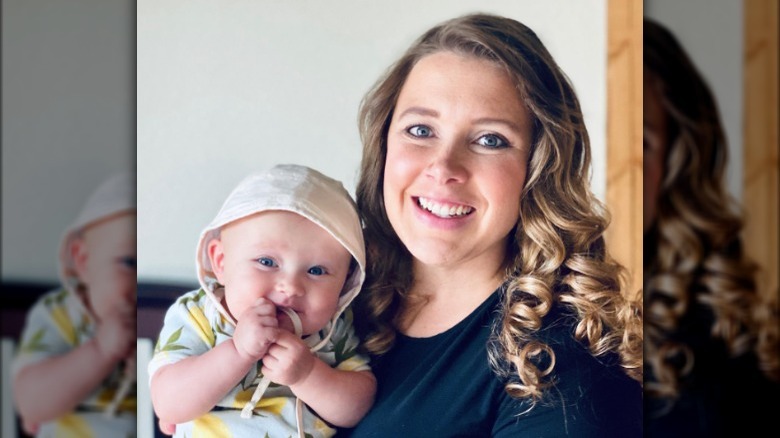 Anna Duggar holding one of her children