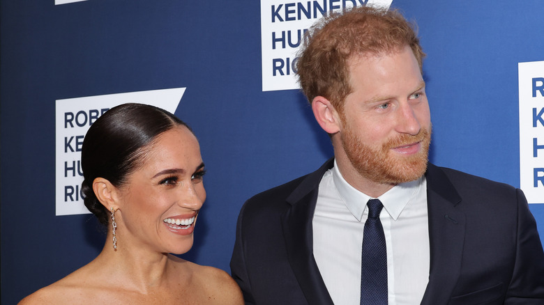 Meghan Markle and Prince Harry smiling at an event