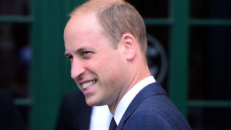 Prince William smiling for cameras