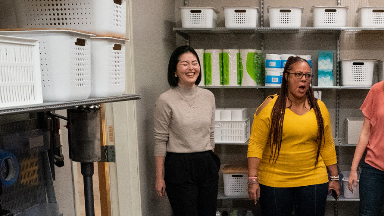 Marie Kondo standing in room of bins with others