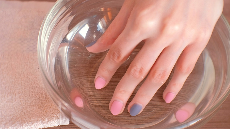 holding wet nails in water