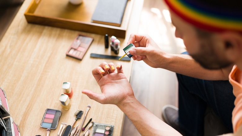 man painting his nails