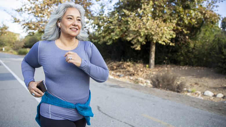 older woman running outside