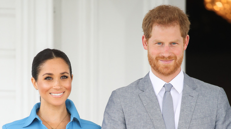 Meghan and Harry smiling at an event