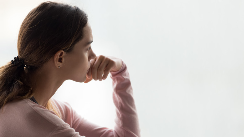 Sad woman at window