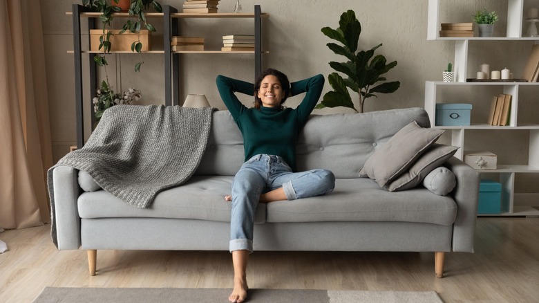 Woman relaxing on couch in an organized livingroom