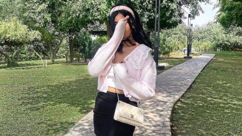 girl in pink cardigan with lace collar